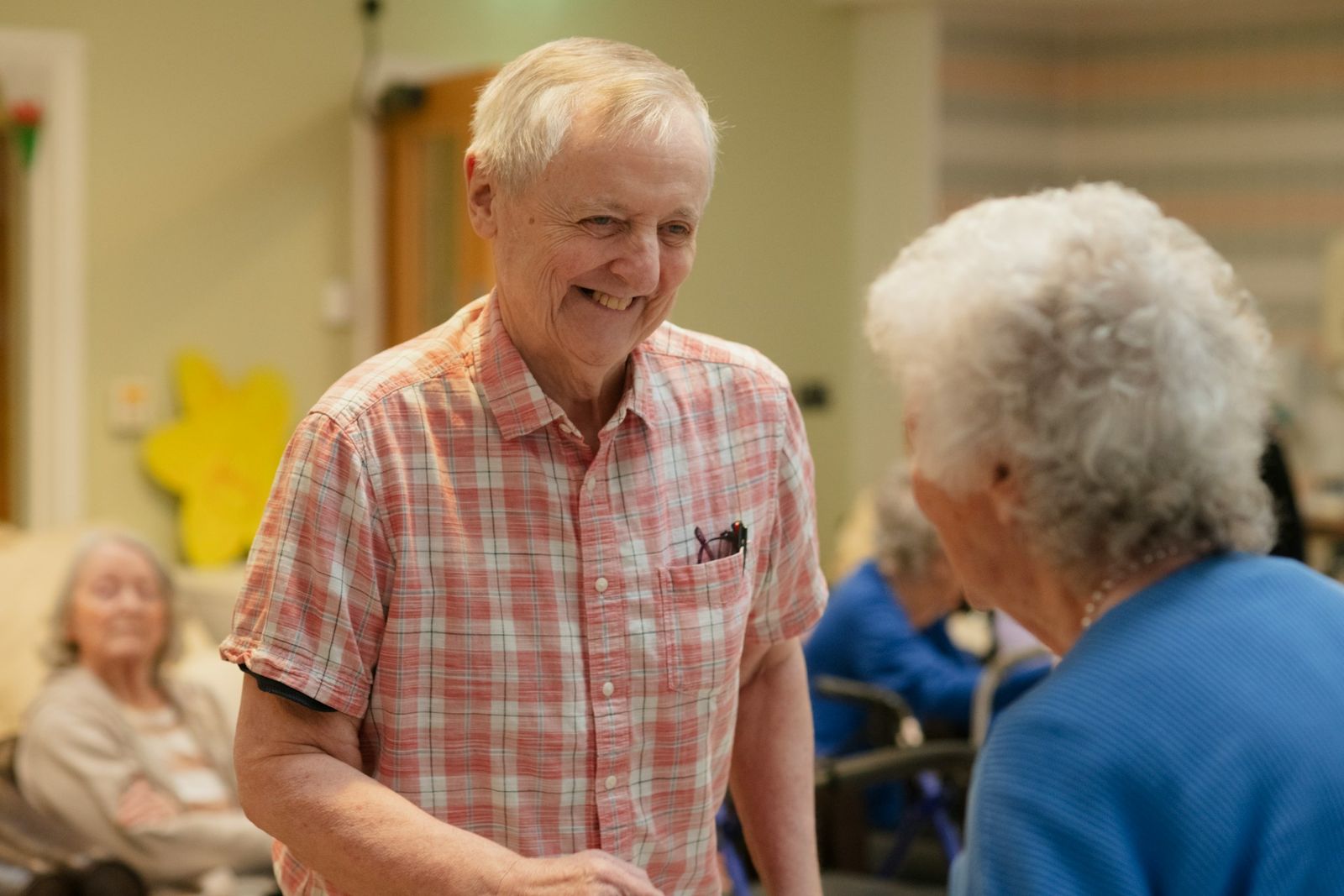 Two older friends smiling as they talk